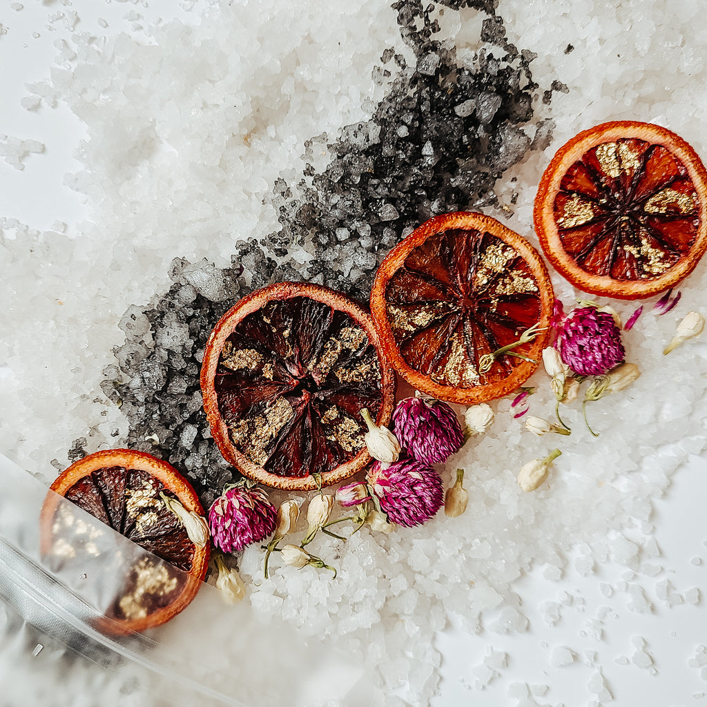 Dead sea salt and hawaiian black salt with golden blood orange wheels, gomphrena and jasmine
